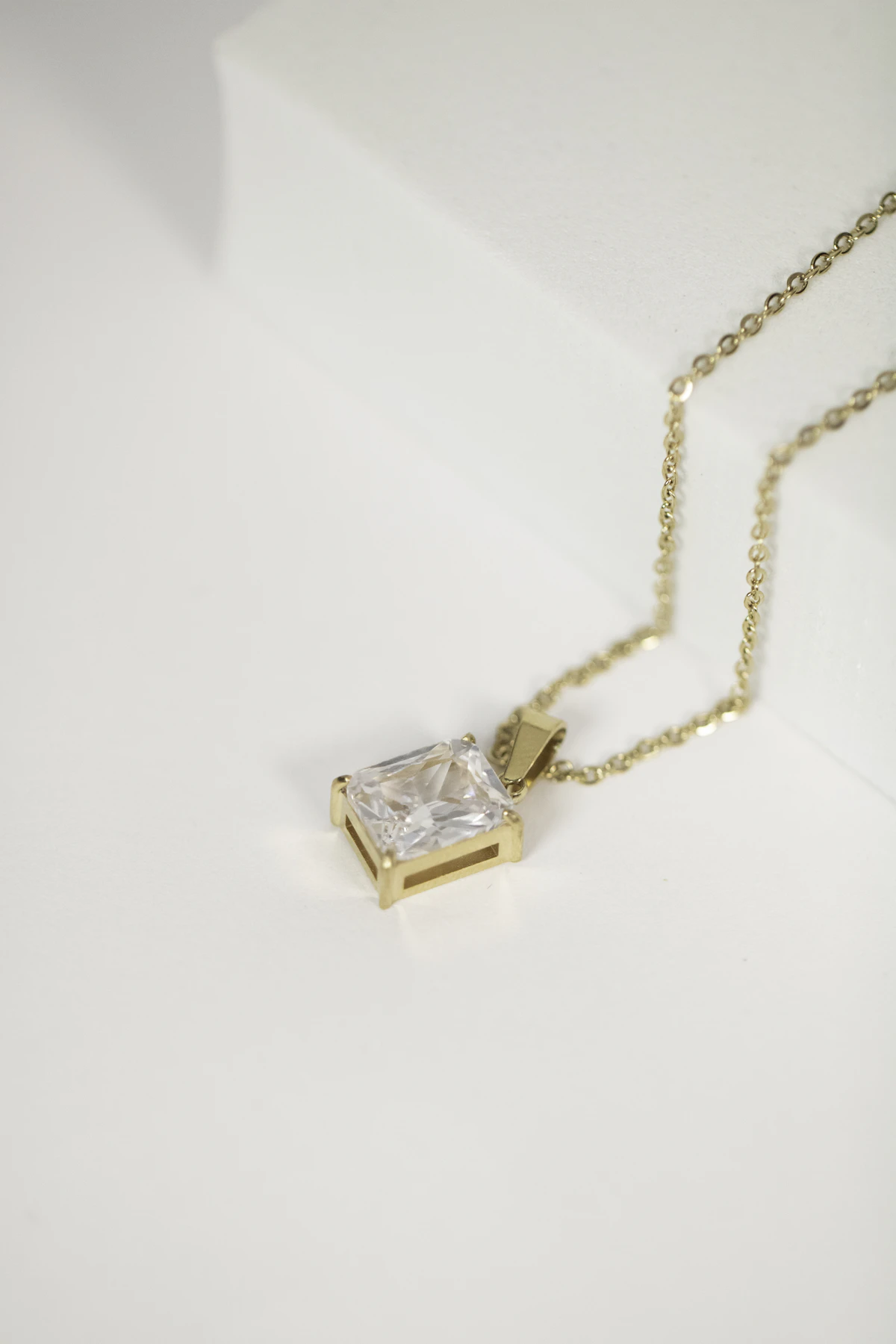 Square-cut diamond pendant on a fine gold chain