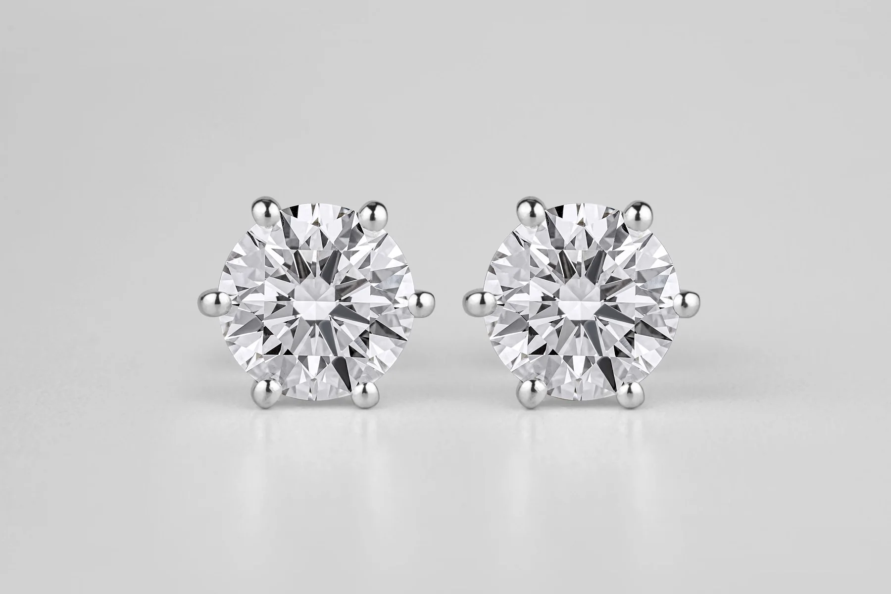 Round diamond stud earrings in six-prong white gold settings