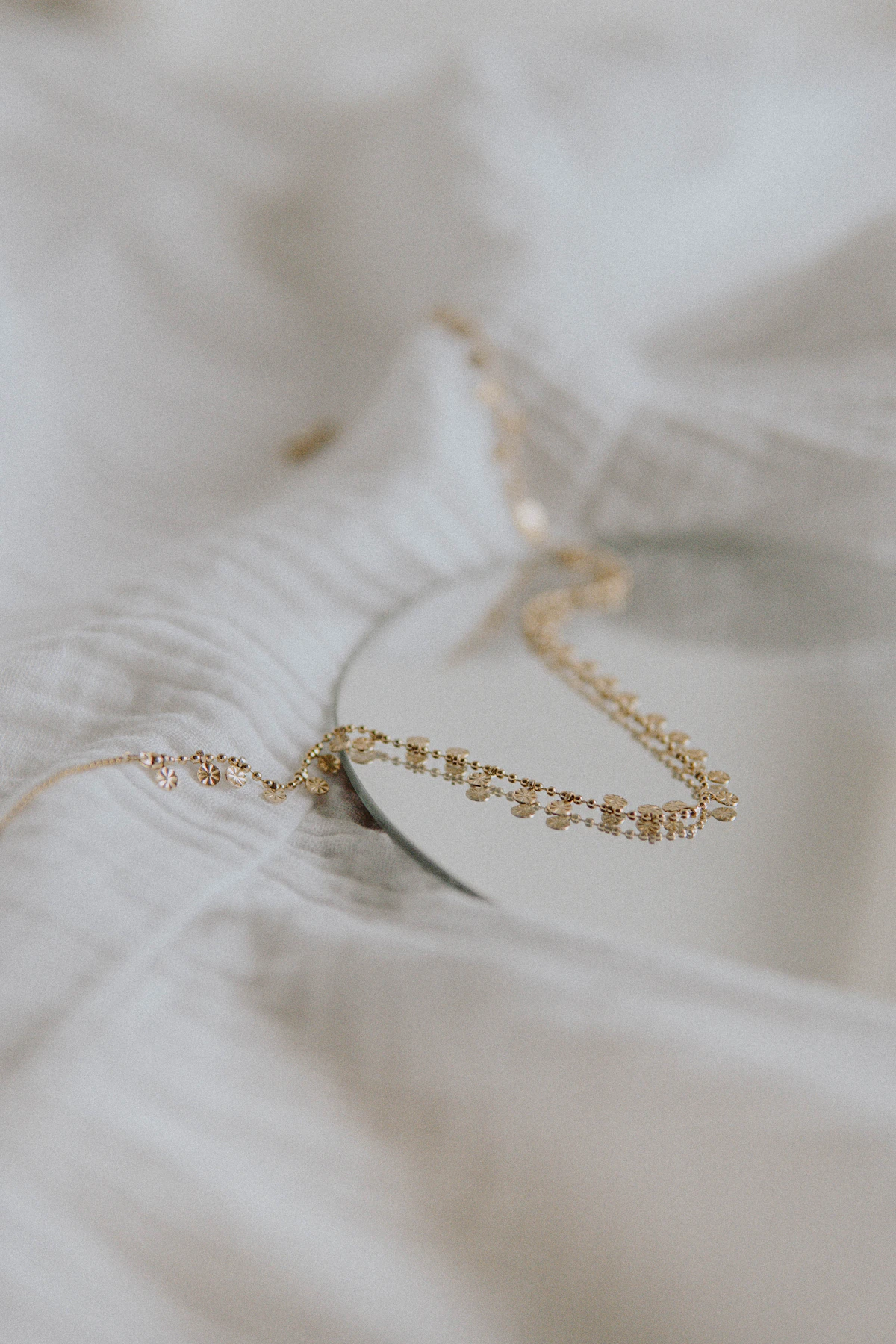 Delicate gold chain necklace on linen