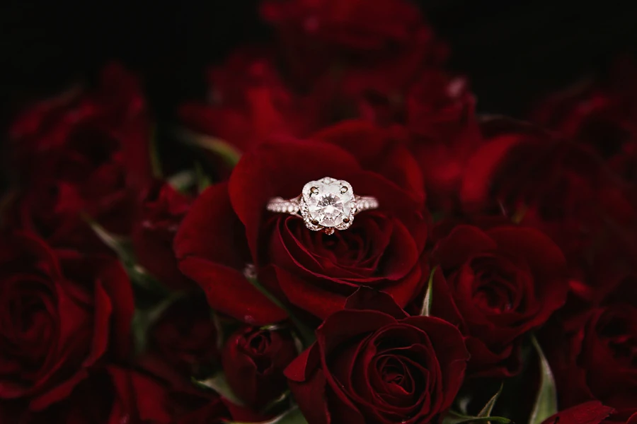 Diamond ring resting on red roses