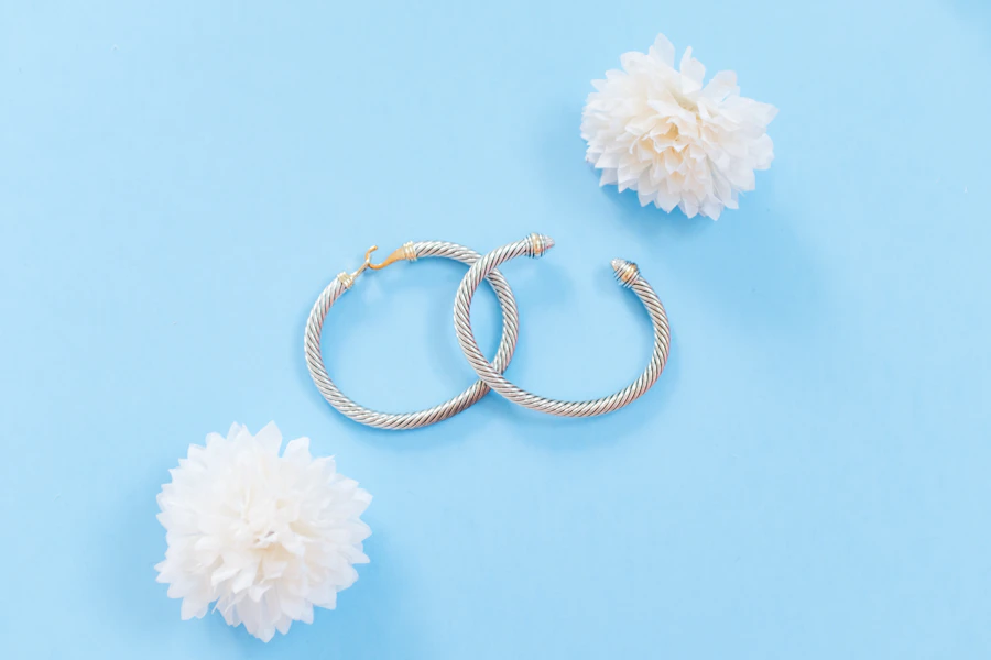 Twisted gold hoop earrings with white flowers
